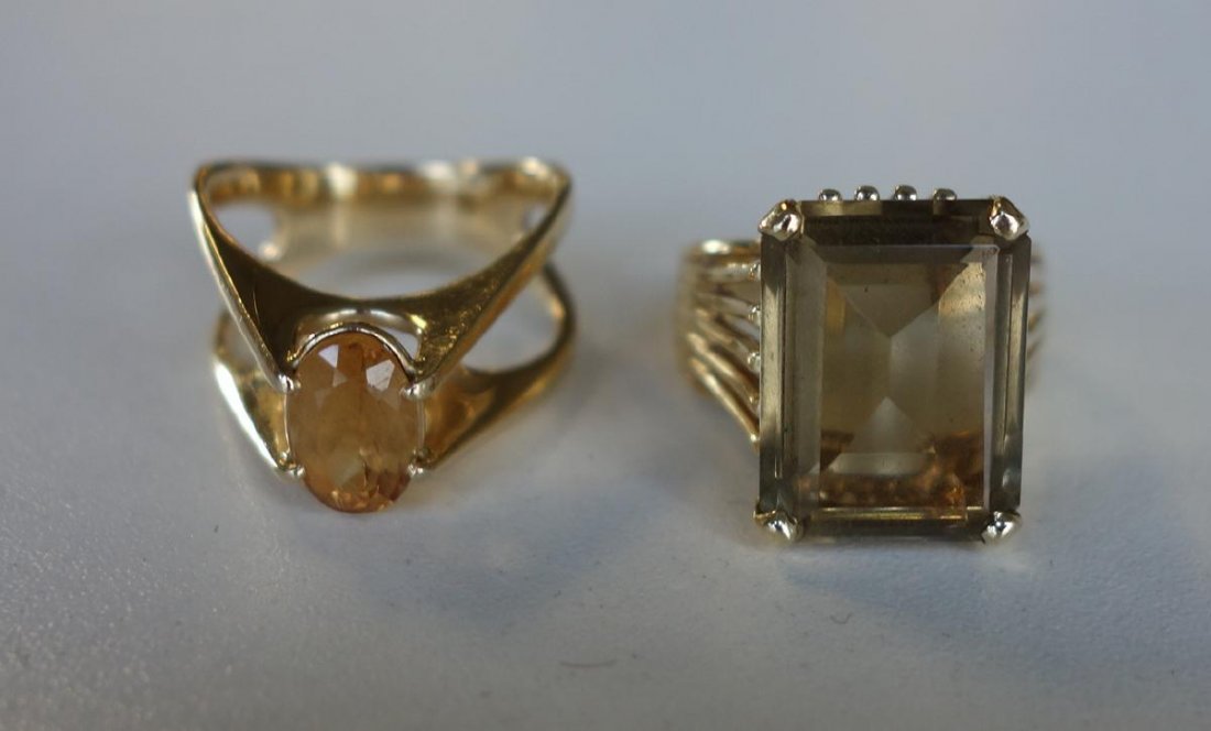 14K Gold, Citrine & Tourmaline Modernist Rings: Two 14K gold Modernist design cocktail rings. One set with an oval solitaire citrine. The other set with a tourmaline. Sizes 6.75 to approximately 7. Weight including stones 15 grams.