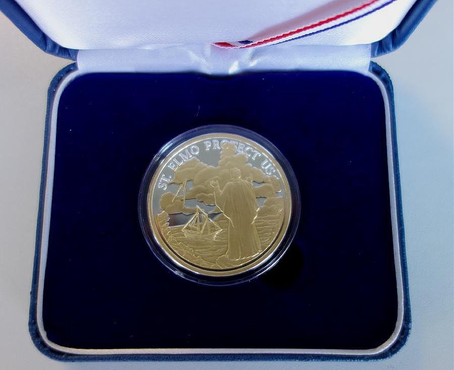 Sterling & 24K Gold St Elmo Coin Saint of Mariners: A .999 pure silver medallion coin partially plated with 24 karat gold, commemorating Saint Elmo, the patron saint of Mariners, seeking aid and protection. Northwest Territorial Mint. Set in a protecti