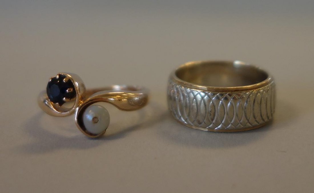 14K Gold Wedding Band & Topaz Ring: A 14K white and yellow gold wedding band (ring size 5). Together with a 14K gold ring set with a faceted topaz and a pearl (ring size 6.5). Overall weight of the two, 8.9 grams.