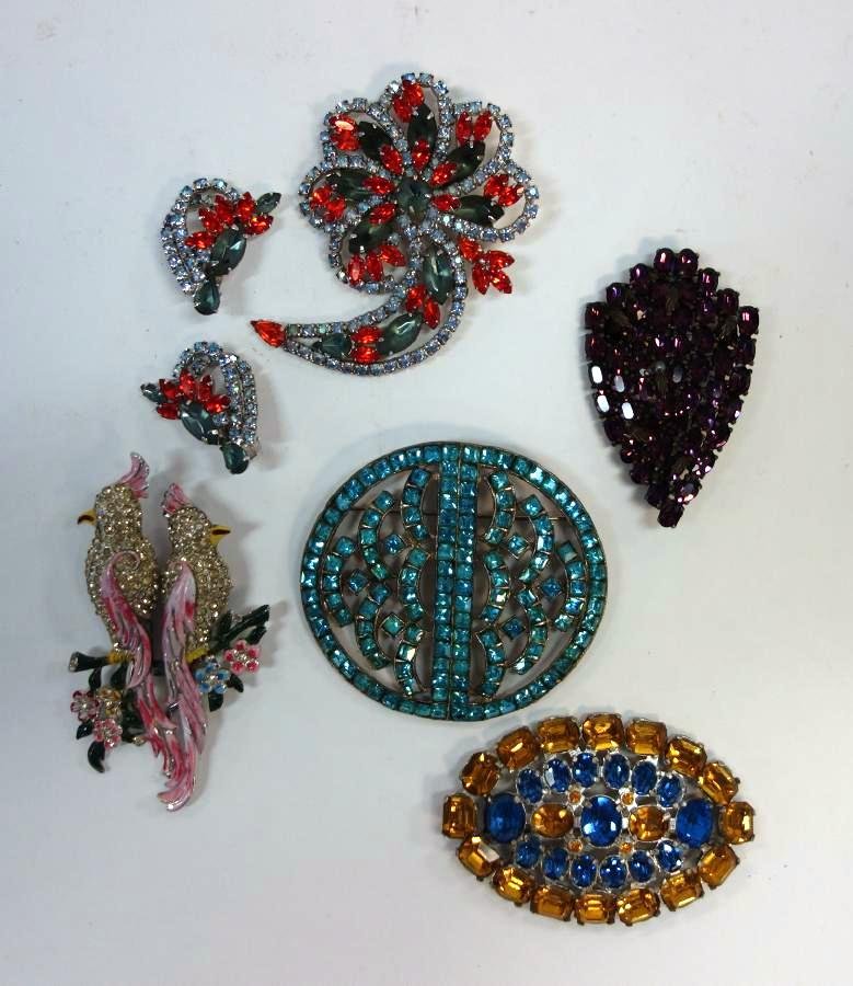 5 Costume Jewelry Brooch Pins, Coco Duette +: A group of five costume jewelry brooch pins. The cockatoo brooch by Coro Duette. One floral formed brooch with matching earrings. The largest round piece measuring 3" x 2.75".