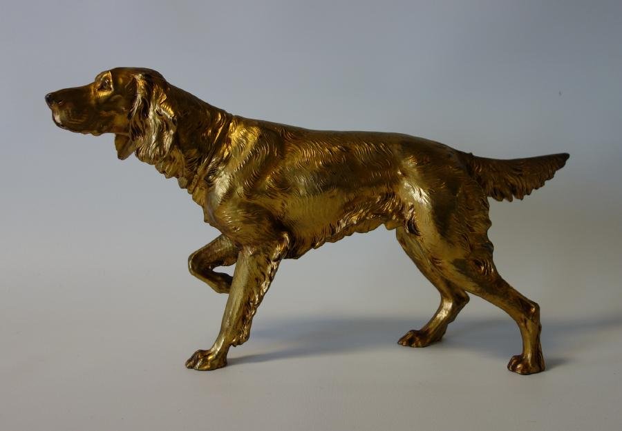 Jennings Brothers Gilt Metal Hunting Dog: A Jennings Brothers gilt metal / spelter model of a retriever / Irish setter hunting dog. Measures 9.5" high, 16.5" long, 3.5" wide. The underside with the Maker's initials, JB and the model number 25
