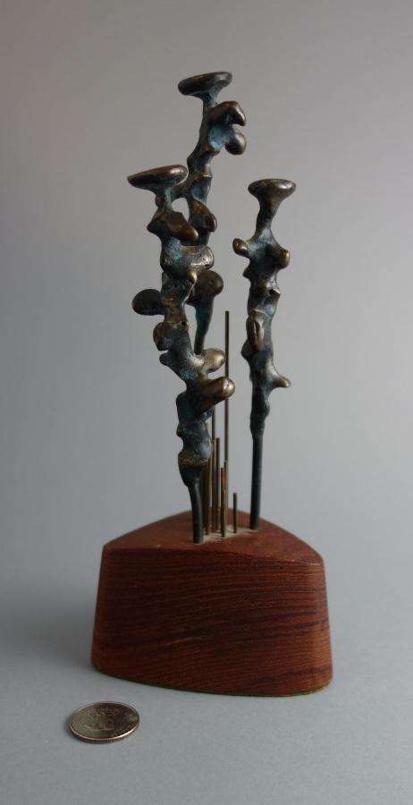 Bronze Figural Sculpture, Style of Henry Moore: A bronze abstract figural sculpture in the style of Henry Spencer Moore (British,1898-1986). Mounted in a wood base. Measures 9" high.