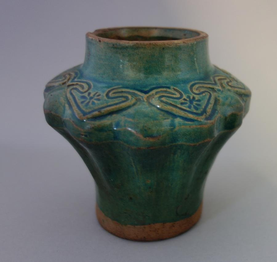 Chinese Ming Dynasty Stoneware Vase: A Chinese stoneware vase, MIng Dynasty. Green fluted vase with incised decoration at neck. Measures 4.5" high, 5" diameter. NOTE: Attached label on underside reads: 15th Cent. Ming-Fluted Vase, Stonew