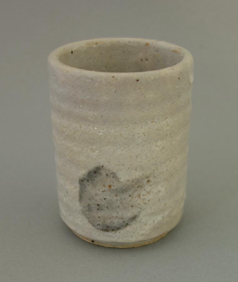 Bernard Leach (1887-1979) Ceramic Vessel: A ceramic vessel by Bernard Leach (1887-1979). Ribbed body with a stylized motif on two sides. Signed underfoot BL (artist's cipher). Measures 3.25" high, 2.5" diameter.