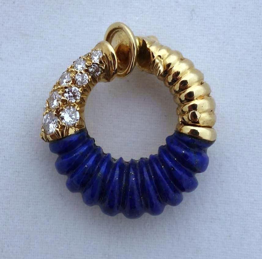 Van Cleef & Arpels Diamond Lapis 18K Gold Earring: A single earring by Van Cleef & Arpels. Hinged design with 14 full cut diamonds set in 18K gold, and with carved lapis lazuli. The earring is stamped VCA, 750, the serial number 830588L4 and French as