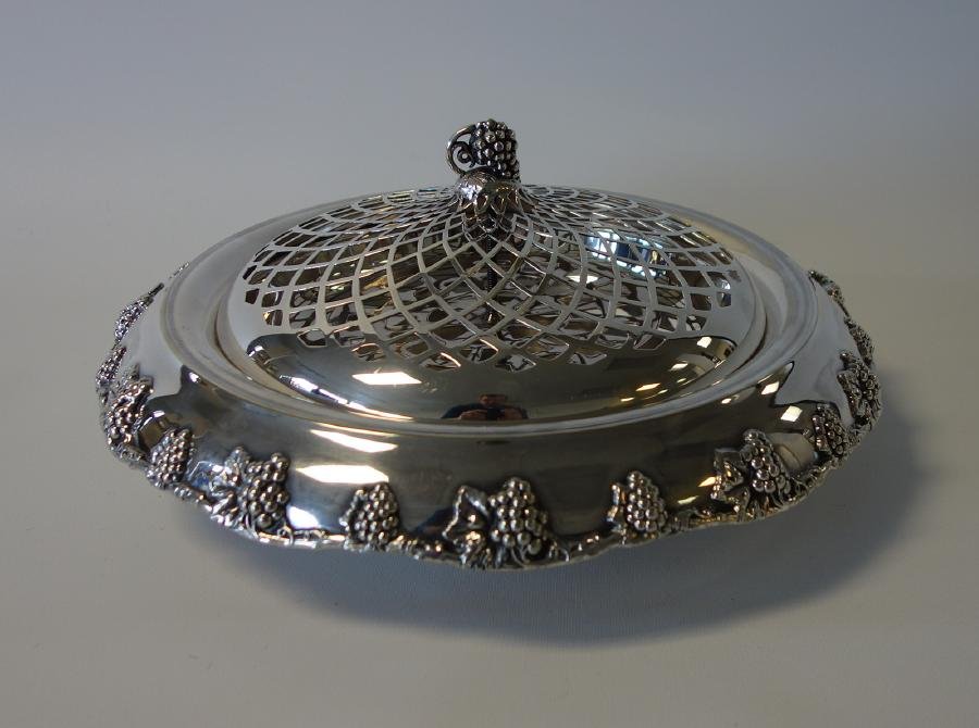 Derby Silverplate Centerpiece Bowl, Edinburgh Ptn.: A silverplate centerpiece, c.1920 by the Derby Silver Co. Edinburgh pattern, composed of a grape, leaf and vine motif. Pierced flower frog lid. Measures 13" diameter, 6" high to top of grape formed fi