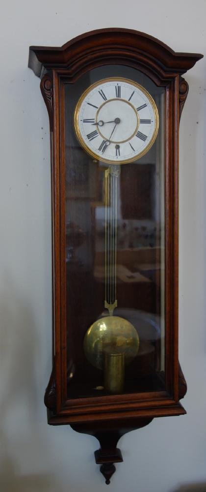 Grand Sonnerie Vienna Regulator Wall Clock: A Grand Sonnerie Vienna regulator wall clock. Single weight driven movement. Walnut and glass case measuring 47" x 16" x 7.5" deep. Enamel face. With pendulum, weight and wind key.