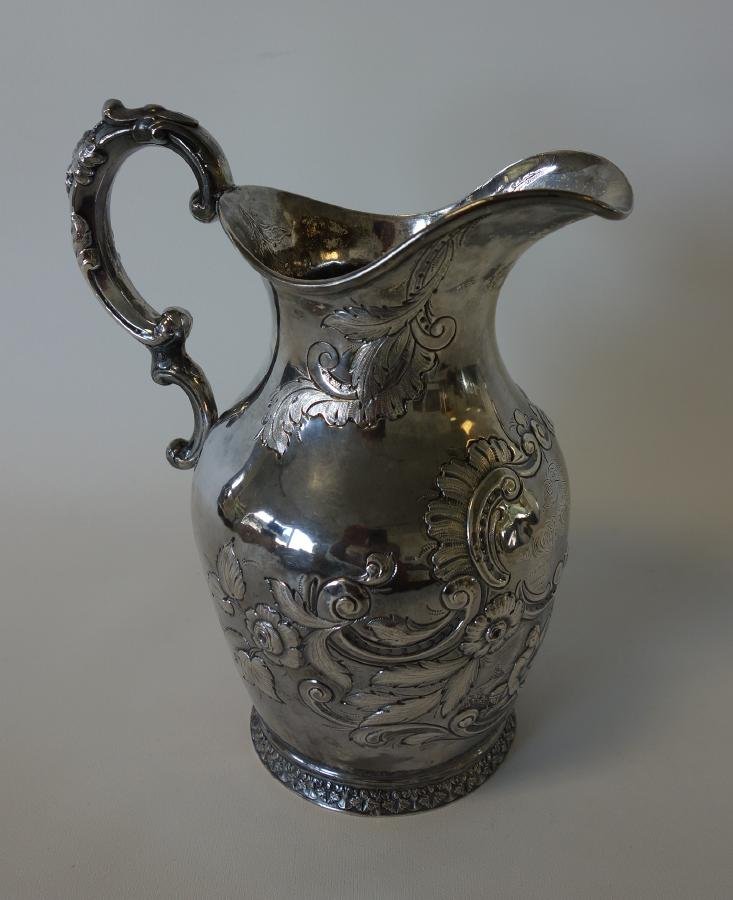 Eber Brock Ward, Silver Presentation Pitcher, c.1851: An American silver water pitcher, presented to Eber Brock Ward in 1851. The engraved inscription reads: Presented to Capt. E. B. Ward, as a token of respect for the uniform courtesy he extends to thos