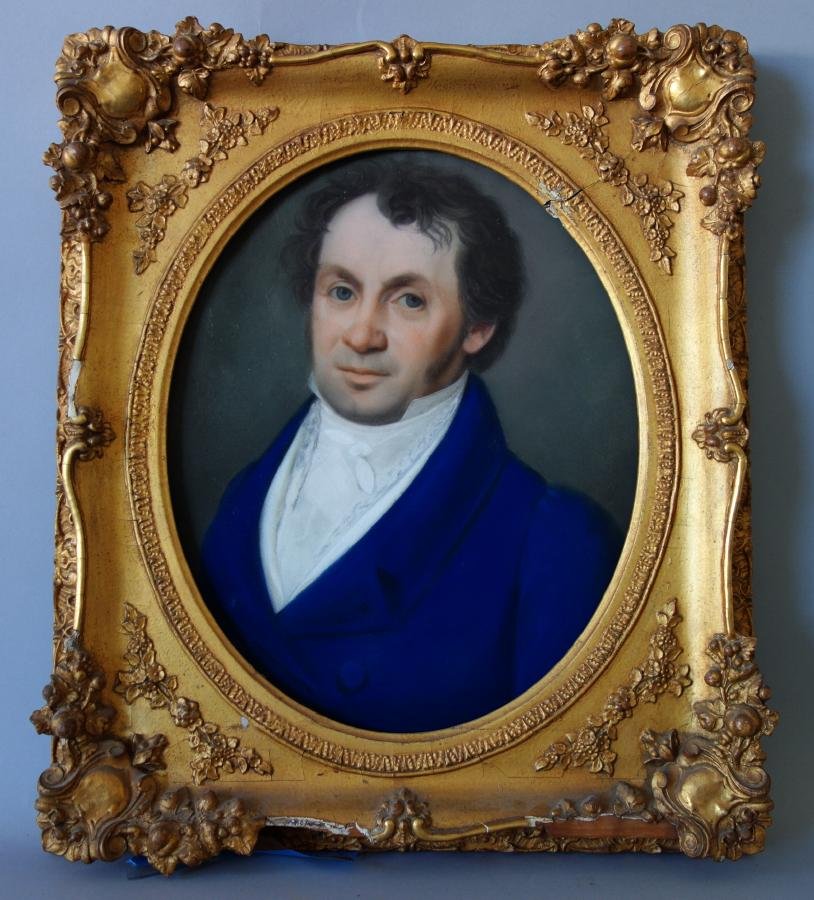 19thc Portrait of a Handsome Gentleman: Framed portrait of a gentleman. The pastel painting depicts a handsome man dressed in a vivid blue formal dress coat with white cravat and collar. Examined outside of frame, measuring 15.75" x 13". Th