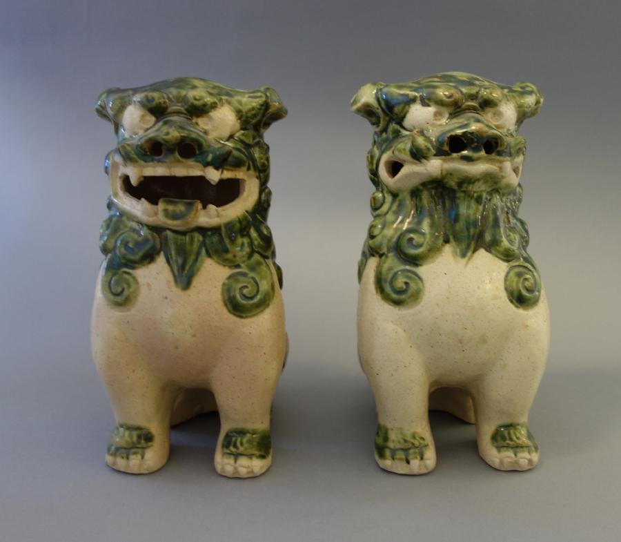 Okinawan Earthenware Pottery Foo Dogs: A pair of Okinawan / Okinawa earthenware pottery foo lion / dogs of Fo; Buddhist guardian lions. Measuring 7" high, 3.25" wide, 5" deep.