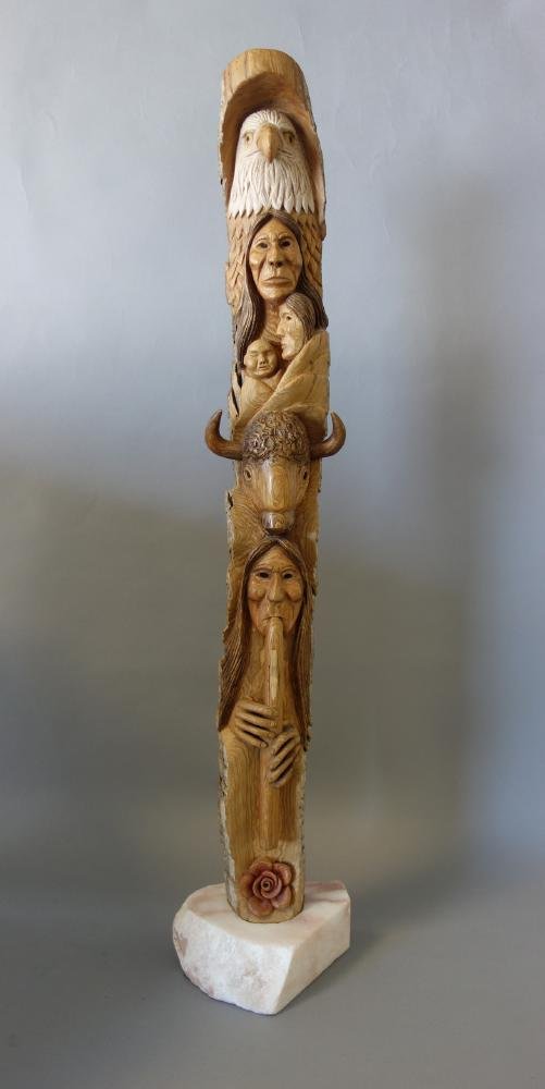 Ed Peekeekoot (Cree Nation) Totem Pole: A carved wood totem pole by Ed Peekeekoot (Cree Nation, Saskatchewan, Canada). Cottonwood carving from British Columbia, Canada. Titled "The Love Flute". Signed and titled on the backside. Overall hei