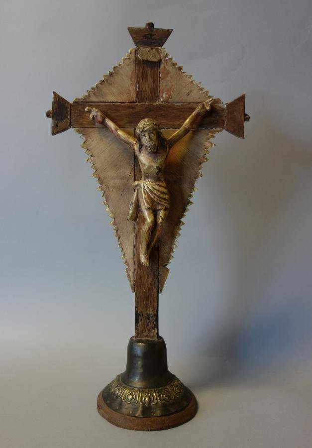 Carved Wood Figure of Jesus Christ on the Cross: A carved wood figure depicting Jesus Christ on the cross, 19th century. Gilt-wood figure of Jesus nailed to a wooden and painted metal cross, supported on a round bronzed and gilt metal base. Measures
