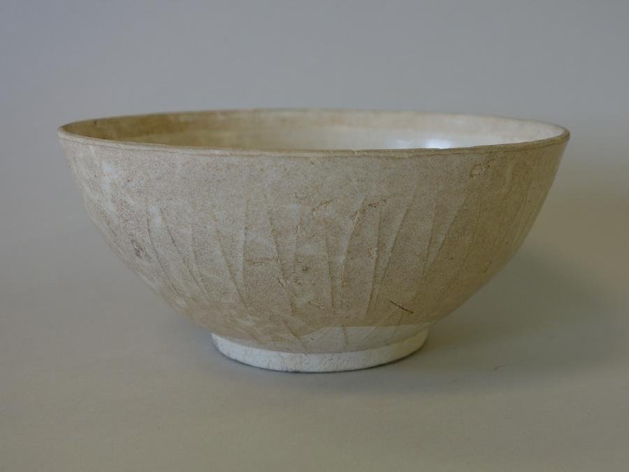 Yuan Dynasty Fukien White Glazed Bowl: An antique Chinese Fukien white glazed bowl. Yuan Dynasty, (1279-1368). Overall raised leaf motif to the exterior. Measures 6" diameter, 2.75" high.
