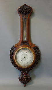 19thc English Barometer, Thomas Armstrong & Bro: An English mahogany and walnut wall barometer. The dial marked T. Armstrong & Bro., 88 & 90 Deansgate, Manchester. The case is well carved in high relief depicting sunflowers / daisies and leaves. She