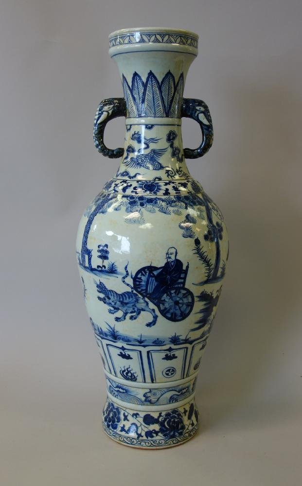 Tall Antique Chinese Porcelain Vase Elephant Hndls: A tall and large antique Chinese porcelain vase. Baluster formed vase, having elephant formed side handles. Underglaze blue and white enamels depicting a male elder in a cart being pulled by two templ