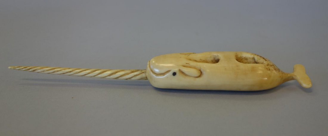 Fossilized Walrus Tusk, Narwhal Carving: A fossilized walrus / marine ivory tusk. Antique primitive Inuit folk art carving depicting a narwhal. Measures 7" long, 1" wide, .75" high. Unsigned. Search terms: Eskimo, Alaskan, Alaska, Narwhale, 