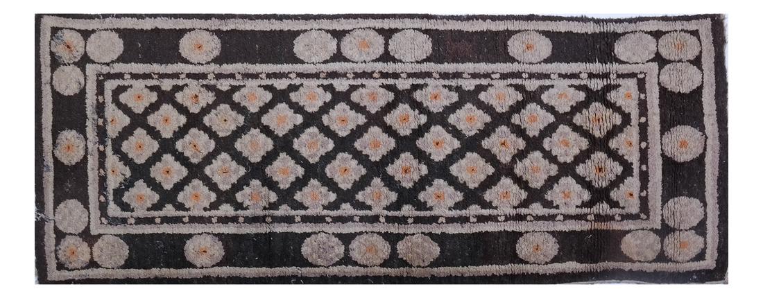 A CHINESE RUG EARLY 20TH CENTURY: The camel field with a rosette trellis 4 ft. 4 in. x 2 ft. 3 in. (approximately)