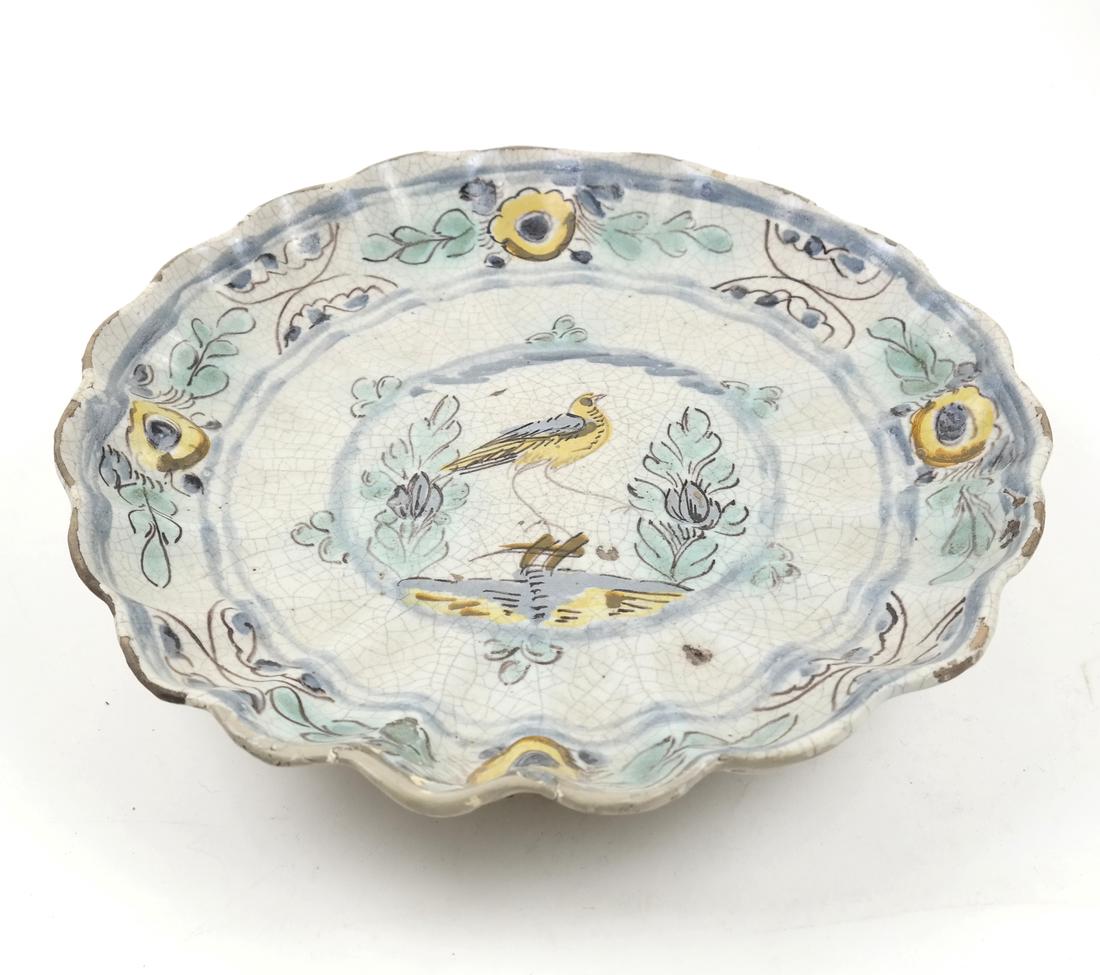 AN EARTHENWARE POLYCHROME TAZZA 18TH/19TH CENTURY: Painted with a central bird, flowers at the rim 11 1/2 in. wide