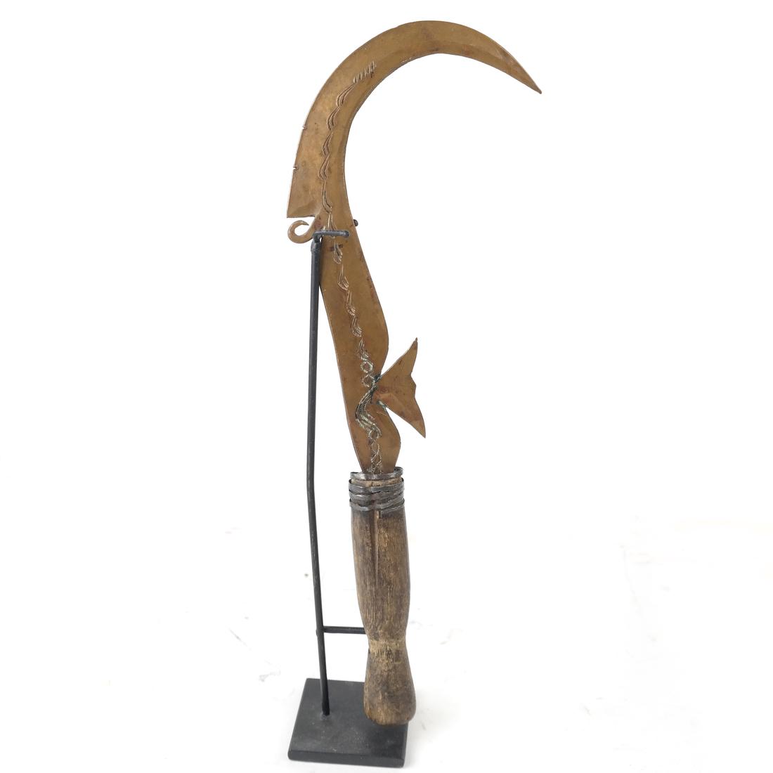 Copper Ceremonial Weapon: Engraved decoration with wood handle, fitted on an iron stand. [Weapon: 11 1/4" L].