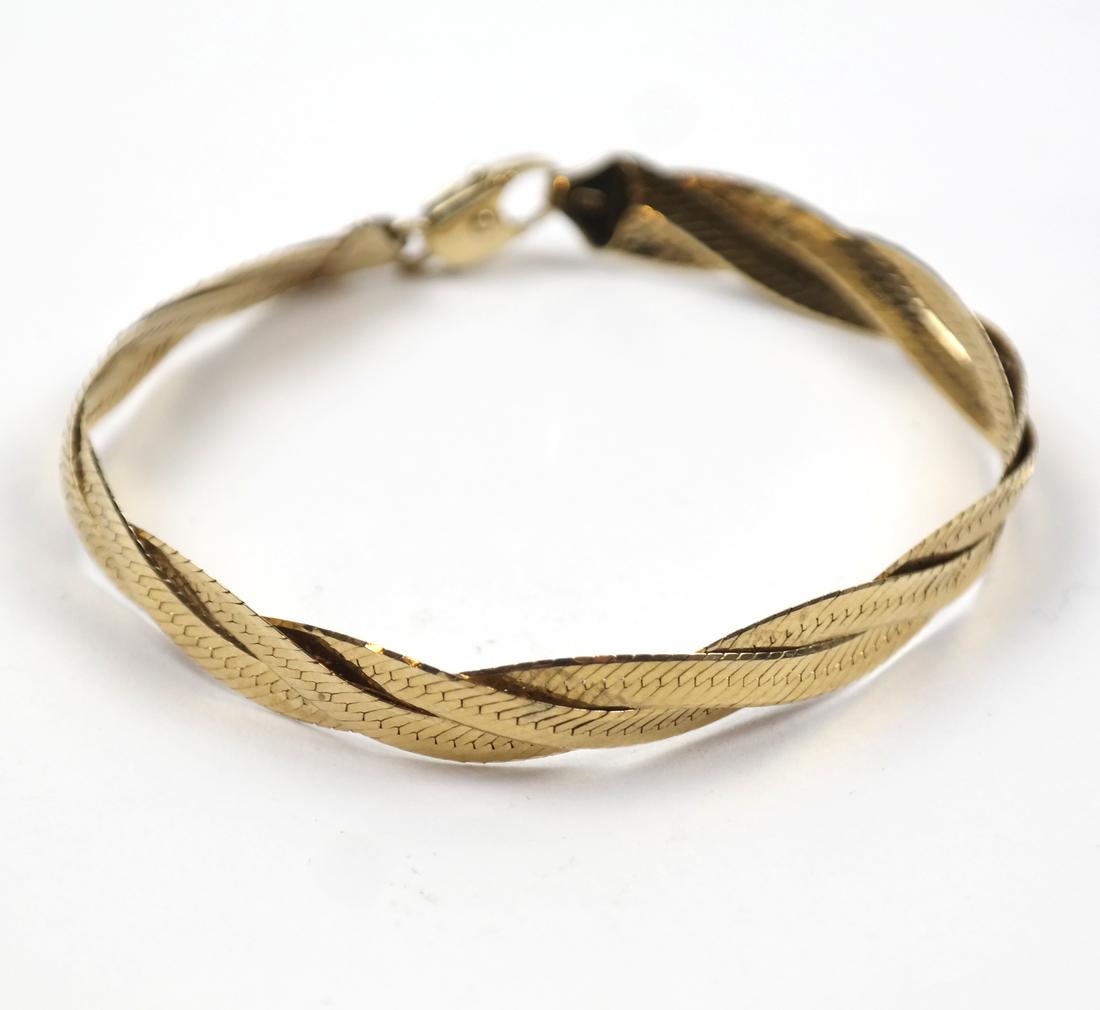 Italian 14k Yellow Gold Bracelet: Modeled as a braided flat chain. [7" L approx.]. Weight approximately 5 dwts.