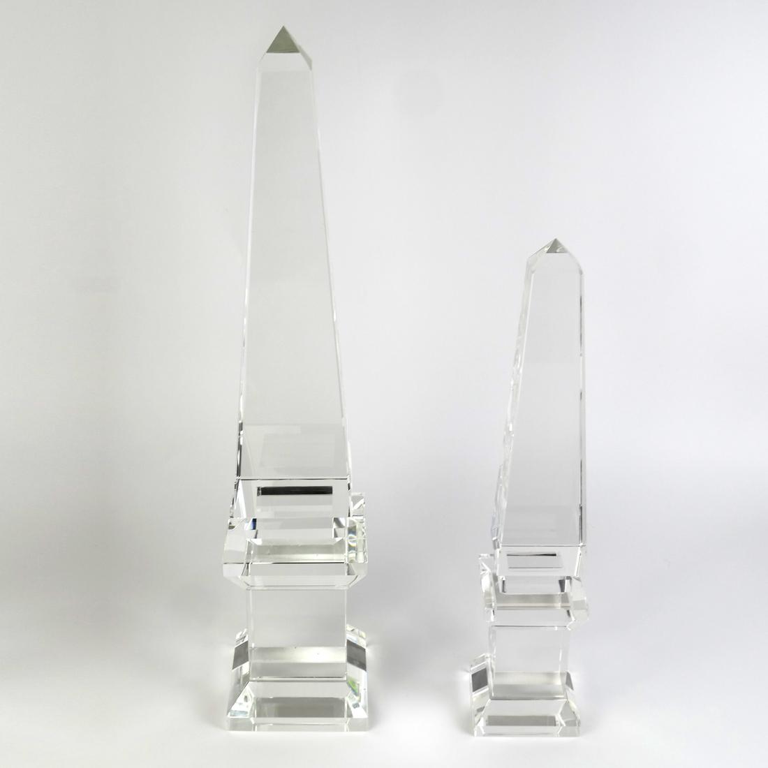 Pair Glass Graduated Obelisks: Late 20th century. [H: 16 1/4" and 21 3/4"; W: 3 1/4" and 4 3/8"]. Each in good condition overall.