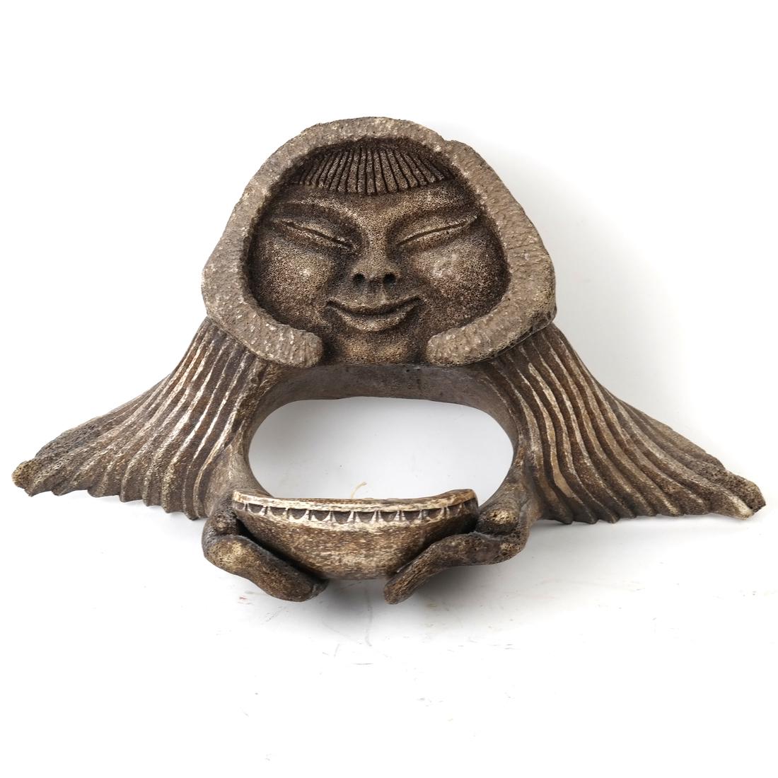 Inuit Whale bone Sculpture: Depicts an native Inuit holding a basket.