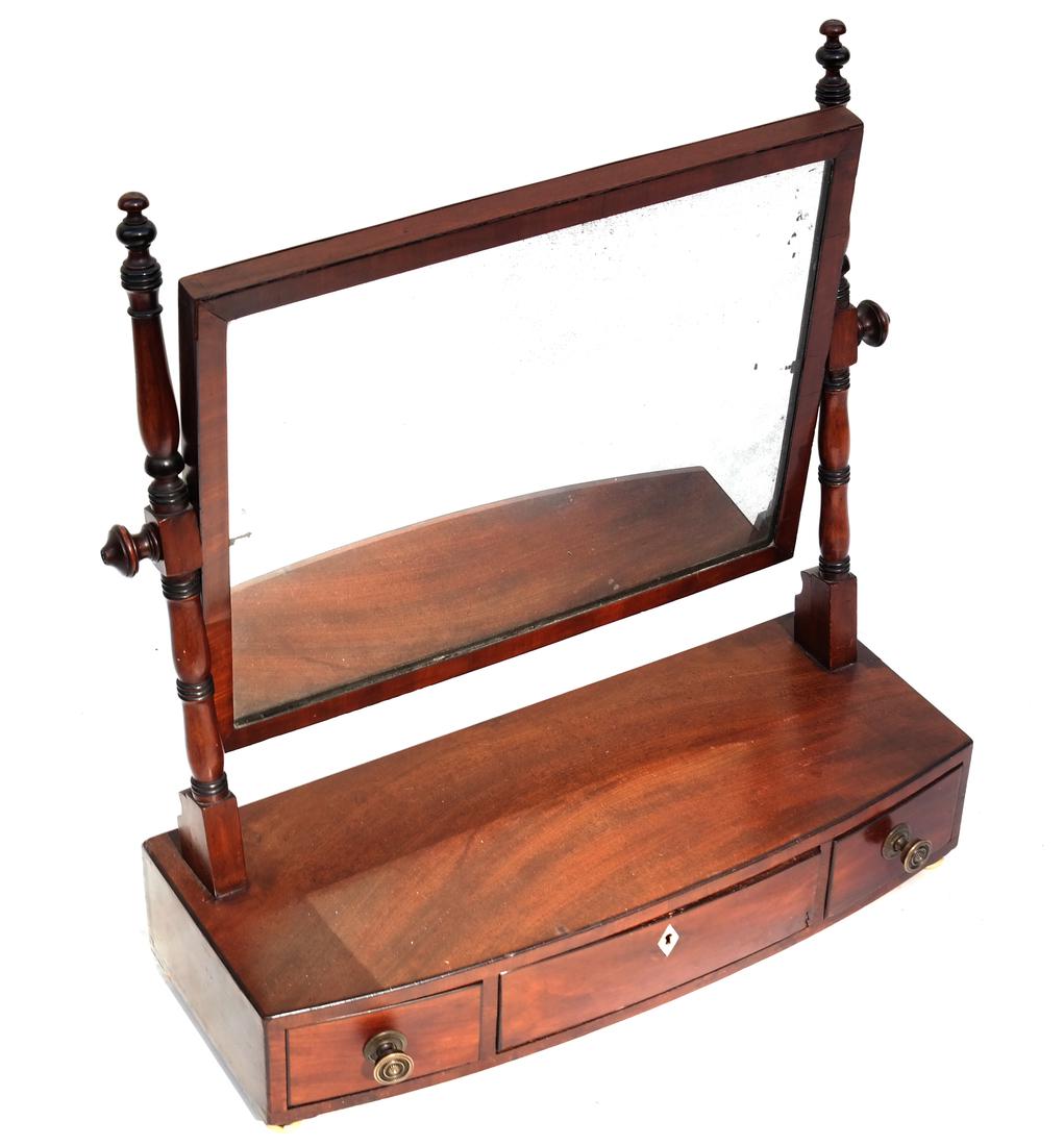 George IV Mahogany Shaving Mirror: 19th century, fitted with a tilting mirror over three short drawers. [21 1/2" x 8 1/2" x 23 1/2"].