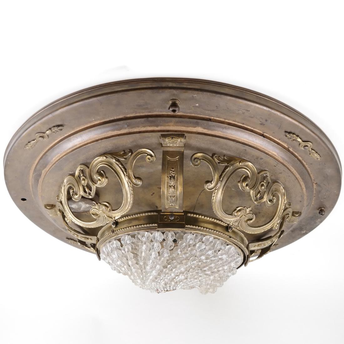 Flush Mount Chandelier: Brass flush mount light fixture with a beaded lower basket. [24" Dia]. Wear.