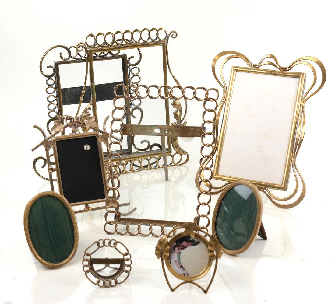 Seven Gilt Metal Frames: Seven various pierced open work gilt metal picture frames. [Largest: 8" H x 5 1/2" W]. Overall good condition with wear.