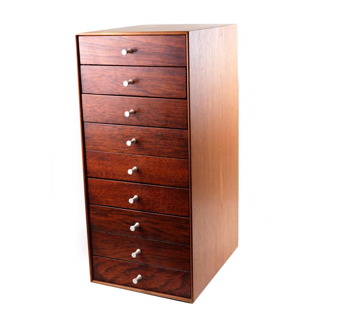 George Nelson Jewelry Cabinet: George Nelson, "Thin Edge" jewelry cabinet designed for Herman Miller. Features teak sides with 9 drawers bearing rosewood fronts and all original white porcelain pulls. Finished on all asides. [10 3/