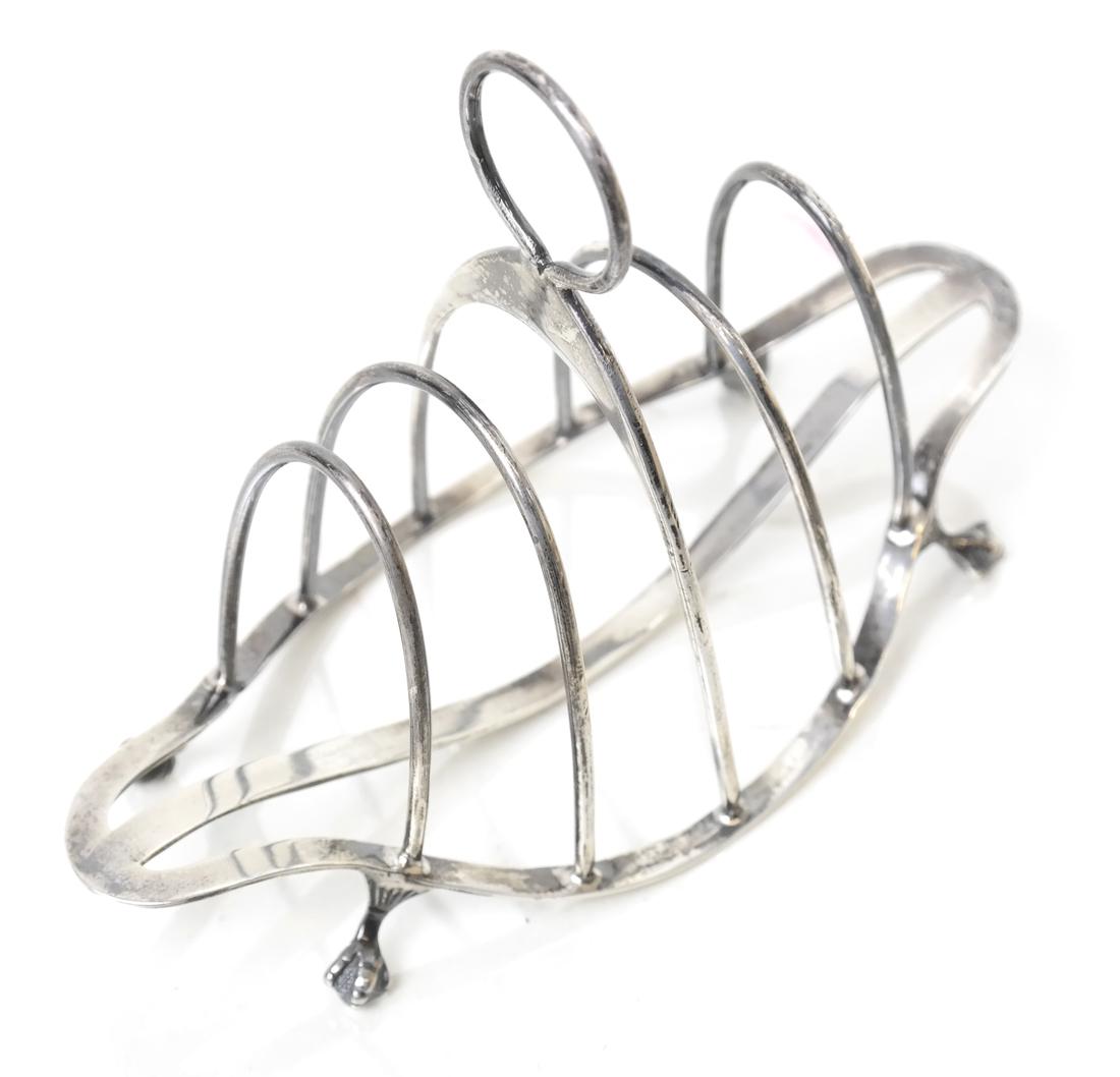 Edwardian Sterling 5-Bar Toast Rack: S & E Co, Birmingham, 1909, of navette form, on ball and claw feet. [4" H x 5 1/2" W x 2 1/2" D]. Weight approx. 2 oz troy. Good overall condition.