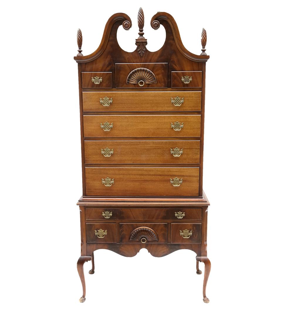 Mahogany Queen Anne-Style Highboy: 11 drawer highboy with two carved shell fronts. Features cabriole legs and scrolling broken arch pediment with three flame-form finials. [37 1/4" W x 18 1/4" D x 80" H]. Light wear.