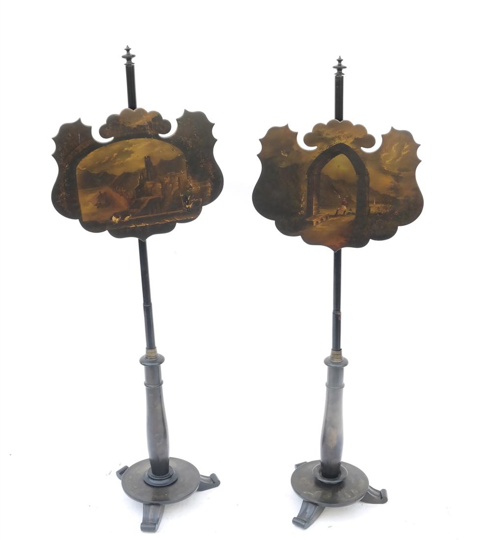 Pair of Papier Mache Screens: Pair of black scenic decorated pole screens. [14 " Dia (base) x 55" H/ Screens: 18 1/4" x 14 1/2"]. Both repaired.Overall good condition.
