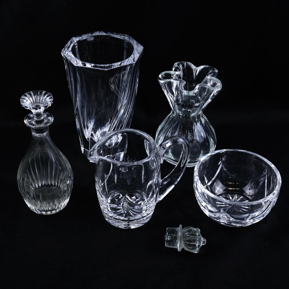 Five Various Glass Vessels: Comprises: 1.) Orrefors hexagonal-form vase [6" H x 4" Dia]. 2.) Small Baccarat decanter with stopper. 3.) Small Waterford glass ewer. 4.) Waterford finger bowl. 5.) Unmarked vase with a handkerchief