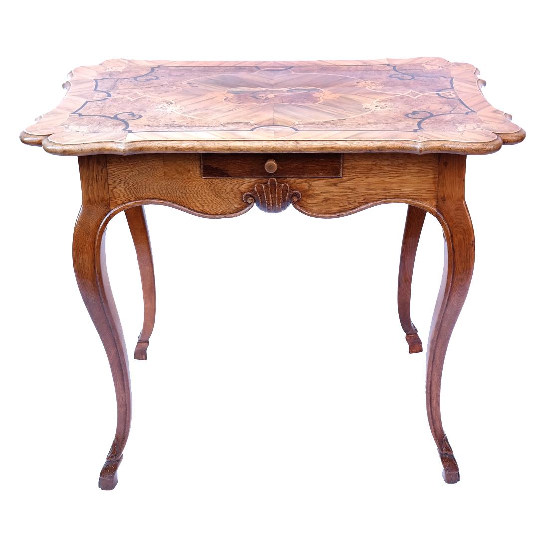 Continental Rococo-Style Games Table: 19th century olivewood rectangular games table having an inlaid central cartouche with a bird. Having a drawer on each side of apron, on cabriole legs that terminate in hoof feet. Label on underside o