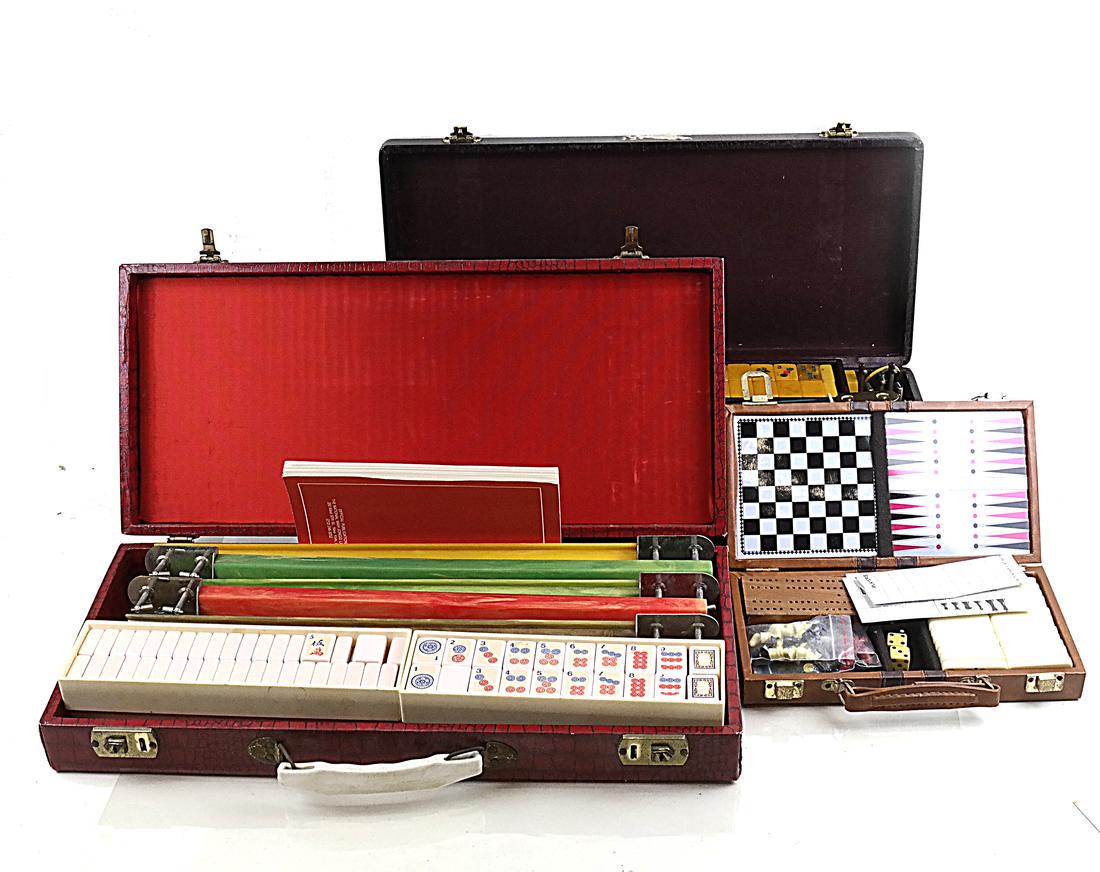Three Vintage Game Sets: Comprises two vintage American Mah Jongg sets with Bakelite racks and tiles and their carrying cases. Together with a traveling chess/ dominoes set. All in used but overall good condition.