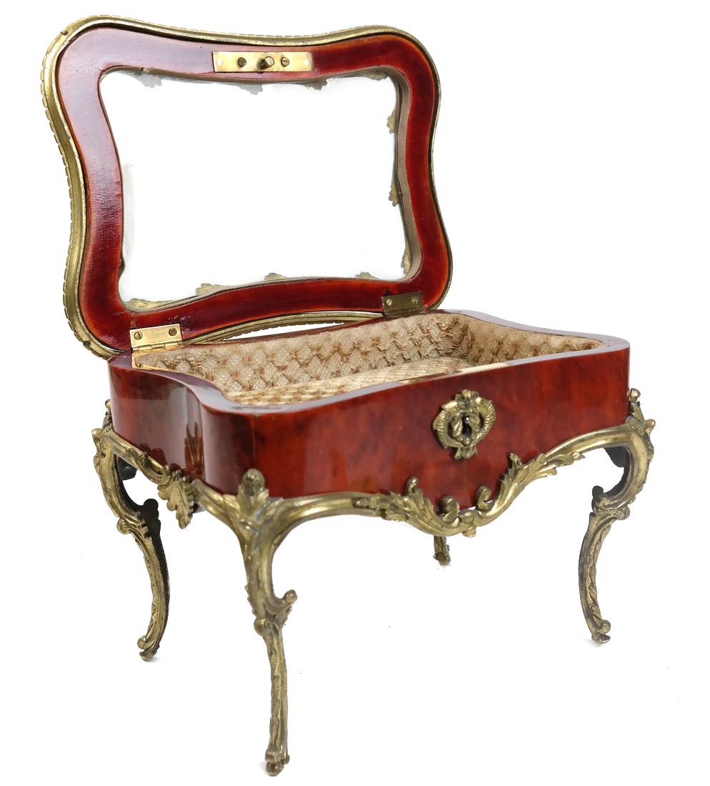 Louis XV-Style Miniature Table Vitrine: A miniature gilt mounted bureau plat-form vitrine, with a hinged beveled glass top, revealing a cushioned lined interior. [9" W x 6" D x 6 3/4" H]. Good condition.