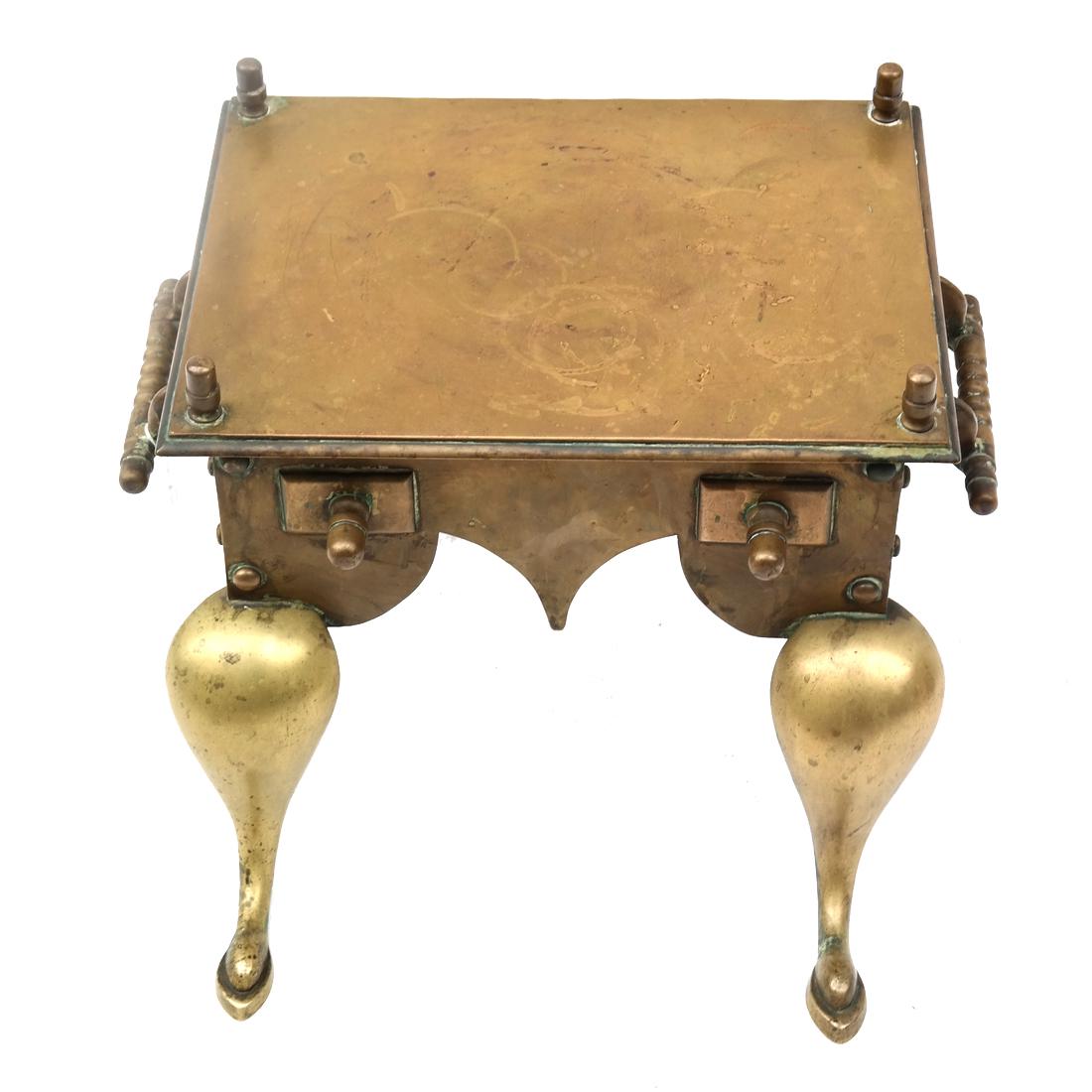 Brass Footman or Trivet: English-style brass footman, with a shaped apron. [13" H x 16" W x 15" D].