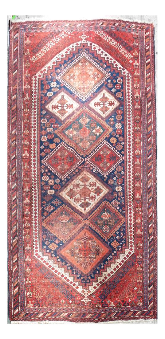 Caucasian Rug: Navy ground with red border, the central field filled with hooked medallions. [97" L x 56" W].