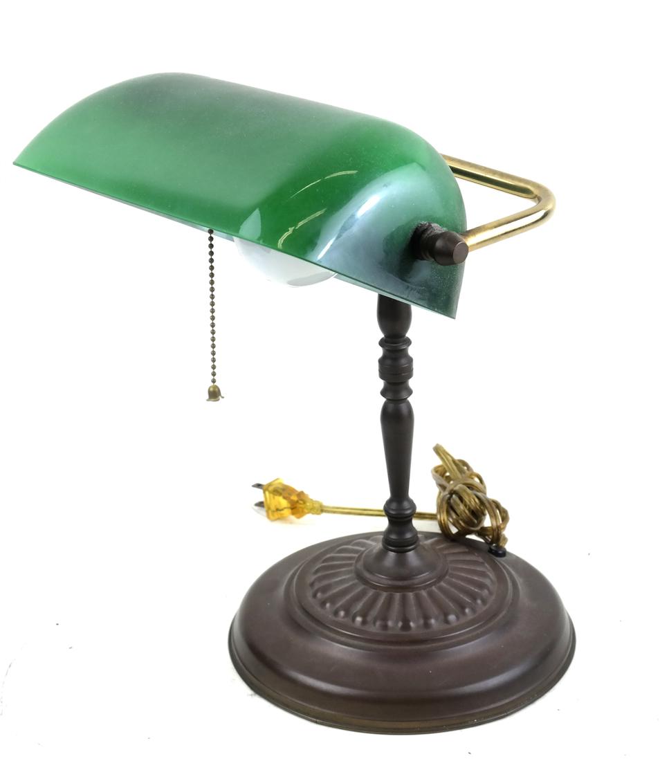 Emerald Glass Banker's Lamp: Brass lamp with an emerald green glass shade. [Shade: 8 3/4" x 5 1/2" x 3; Lamp: 10" x 11 1/4" H]. From the Collection of Will Barnet.