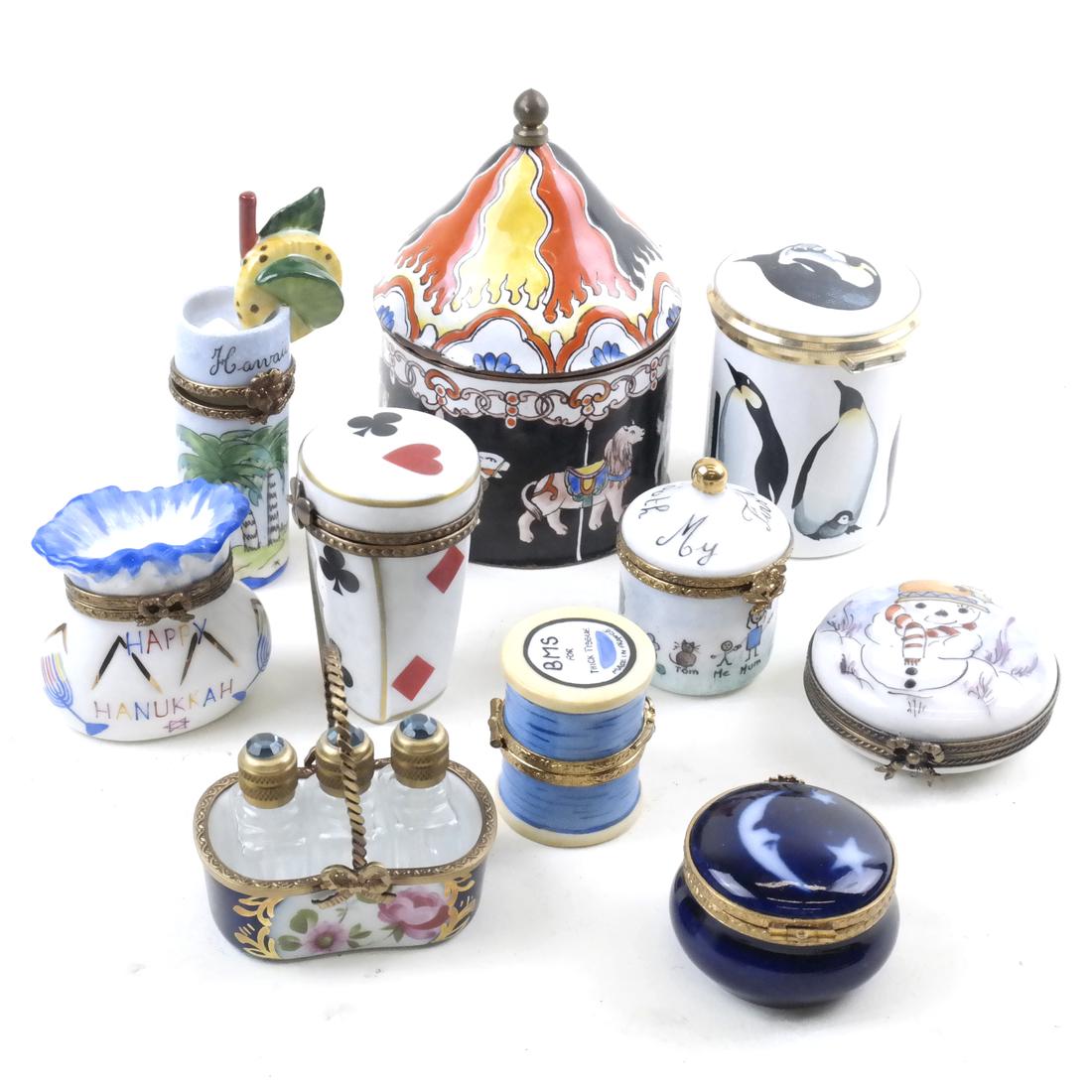10 Various Porcelain Decorative Boxes: Includes: a Limoges spade and hearts box, a Limoges cylindrical-form "tissue" box, a Hanukkah themed pouch box with two loose pieces of "gelt" inside, a Limoges Hawaiian themed box, a Limoges "My Firs