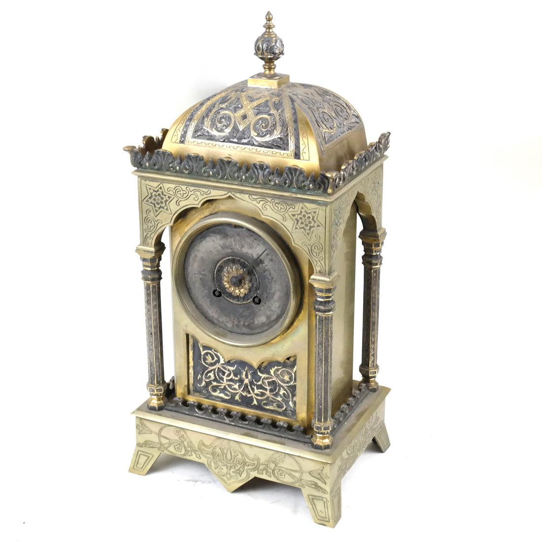 Moorish-Style Bronze Clock: 20th century bronze incised and raised decorated mantle clock with a pendulum. Dimensions: 8" W x 6" D x 16"H; 8" W x 6"&nbs