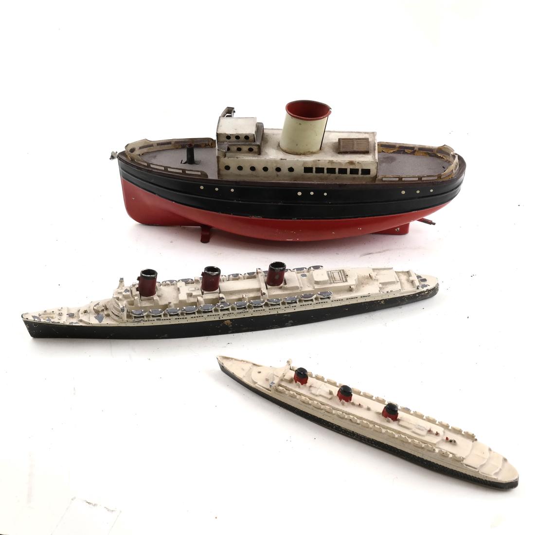 Three Vintage Painted Metal Ship Models: Comprises 2 cast iron ocean liners and a painted tin toy boat. Dimensions: 7" L x 10" W; 