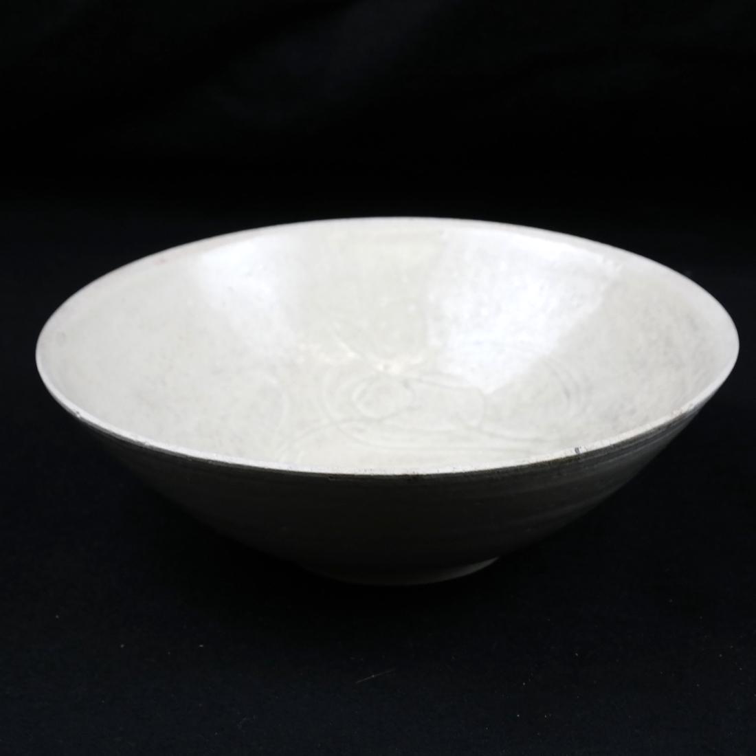 Chinese Creamware Bowl: Glazed pottery bowl under glazed carved scroll design. Dimensions: 9.25" L ; 