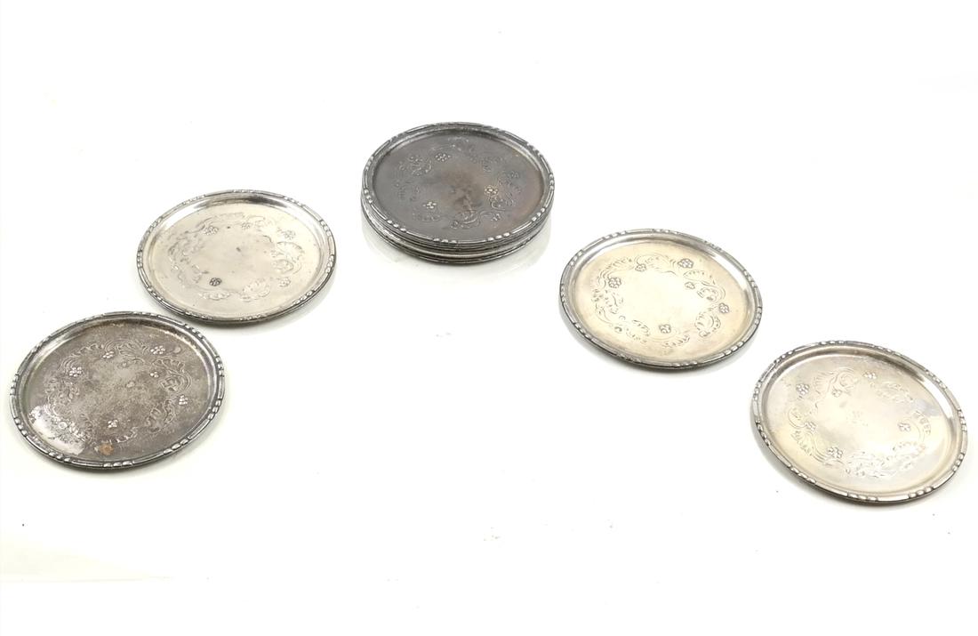 13 Georg Jensen Coasters: 13 Georg Jensen matching coasters. Marked Denmark #51A, E1A, C1A, C1M, etc. 6.1 ozt. Weights: 6.1 ozt (weighted); 