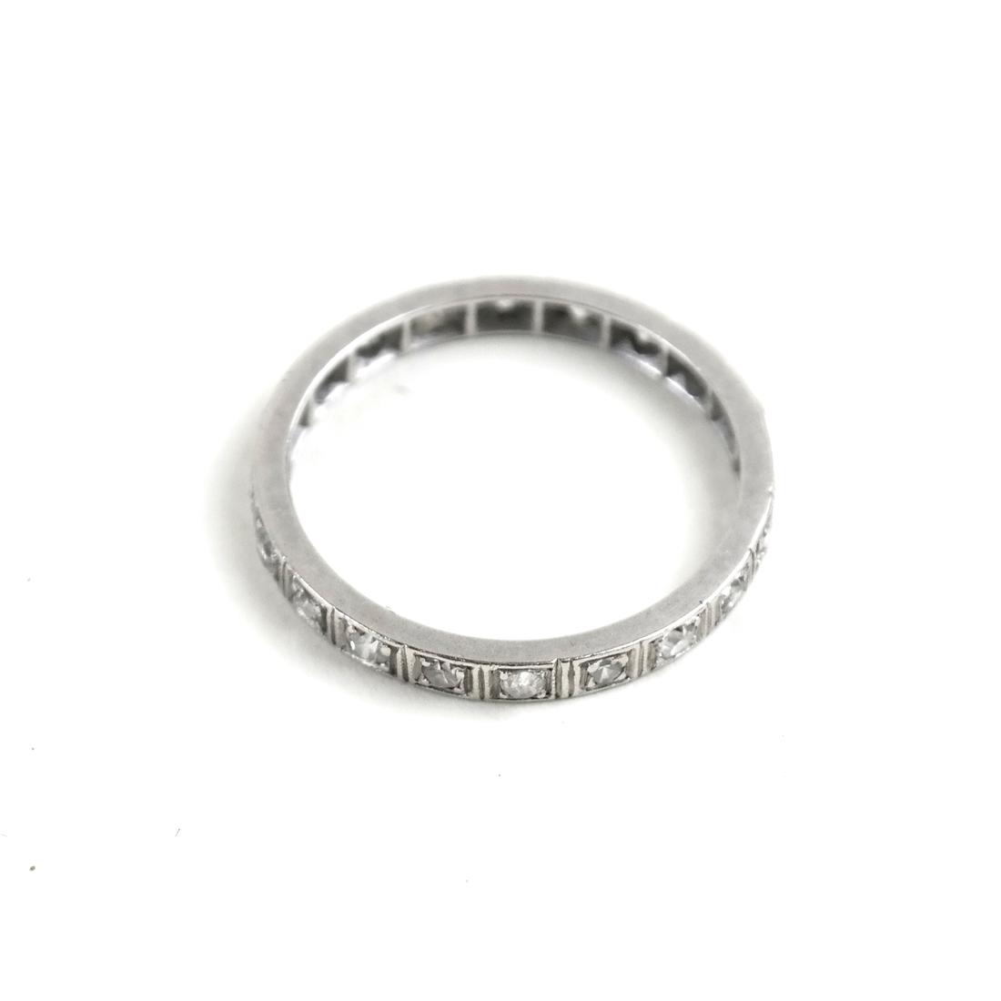 Platinum and Diamond Wedding Band. 1.6 dwt: Platinum and diamond wedding band with 25 round diamonds. Diamonds, .01 carat each; .25 carat total weight estimate. Total weight 1.6 dwt.
