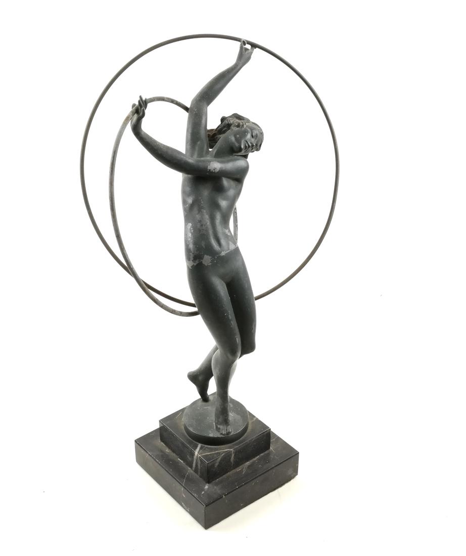 Attributed to Max Le Verrier - Female Nude Hoop Dancer: A metal sculpture of a woman with hoops, as a dancer. Le Verrier Foundry, Paris. On a metal base. Dimensions: 8" W x 4" D x 12"H; 