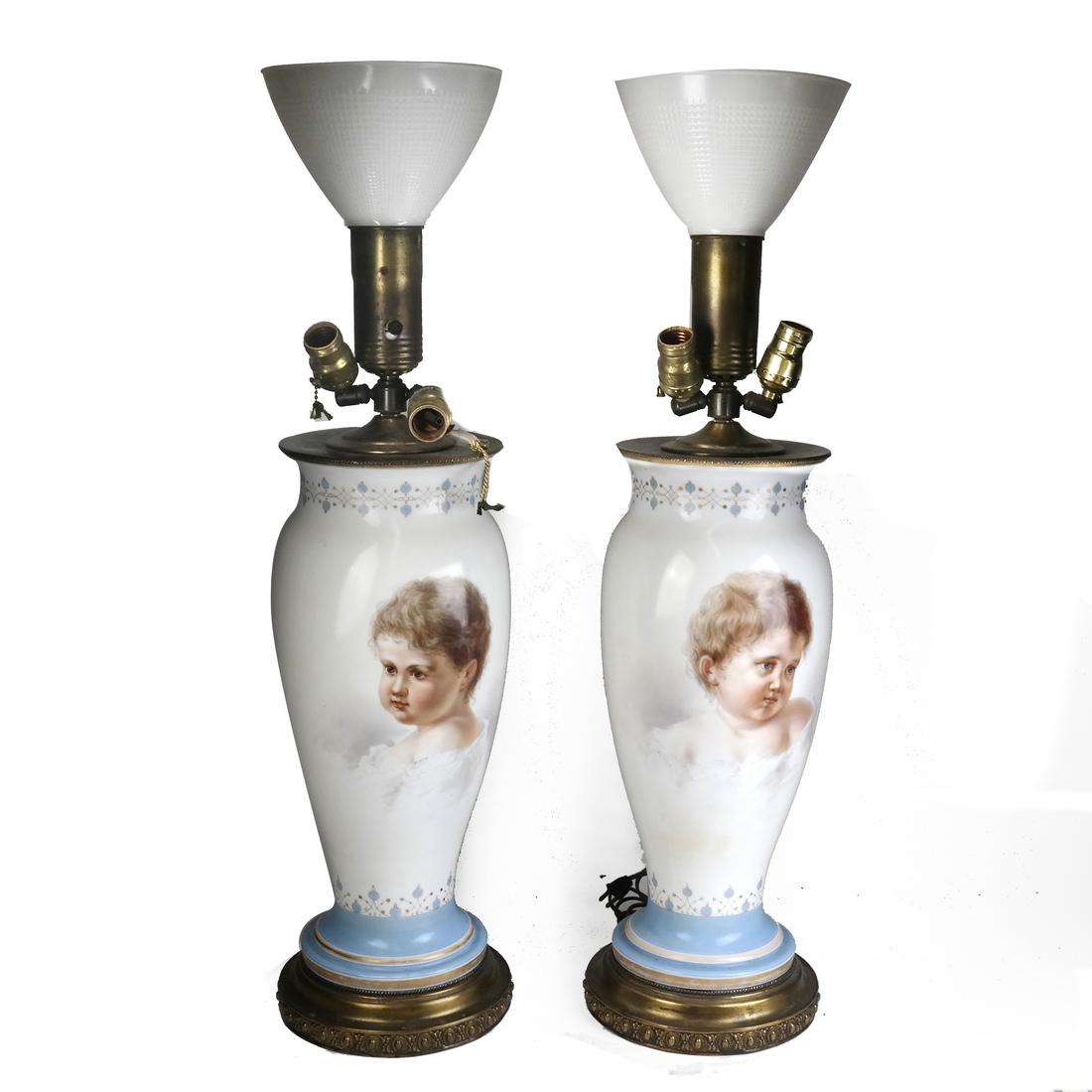 Pair of Opaline Glass Portrait Lamps: Pair of opaline glass portrait lamps, with opposing scenes of children. Dimensions: 8" ⌀ ; (height to socket) - 28.5" H ; 