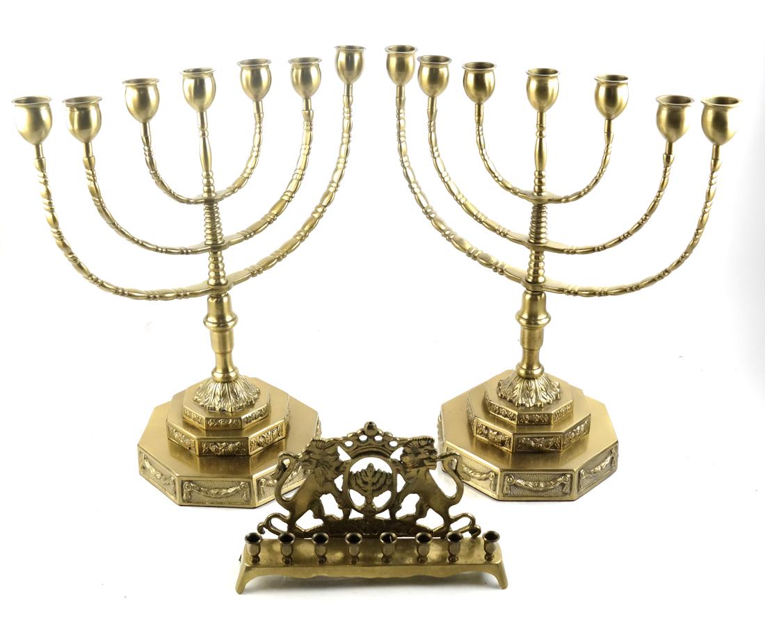 Judaica: Pair of Brass Menorahs; Single Menorah: On octagonal stepped bases. Accompanied by a third example with bracket back featuring lions of Judah. Late 20th century. Dimensions: 13.25" W x 7" D x 14.6&quo