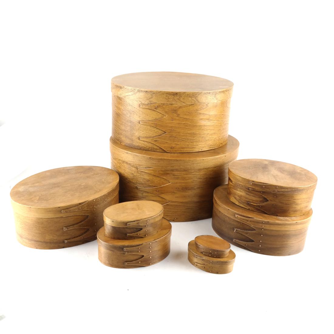 Nine Oval Shape Shaker-Style Boxes: Graduated sizes, the smallest signed by Harry Gigous 11-97. Dimensions: Smallest - 2.5" W x 1.5" D x 1"H; Tallest - 1